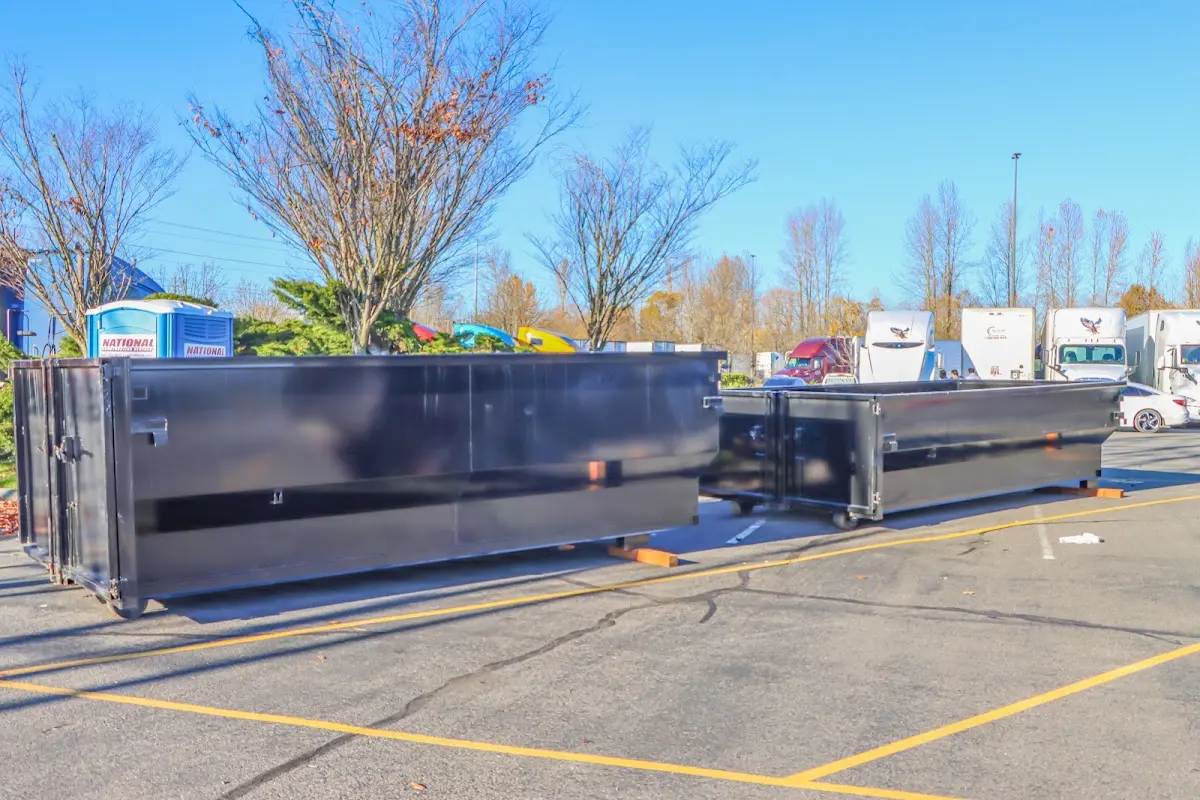 Professional dumpster rental service with roll-off container on residential driveway in North Stonington
